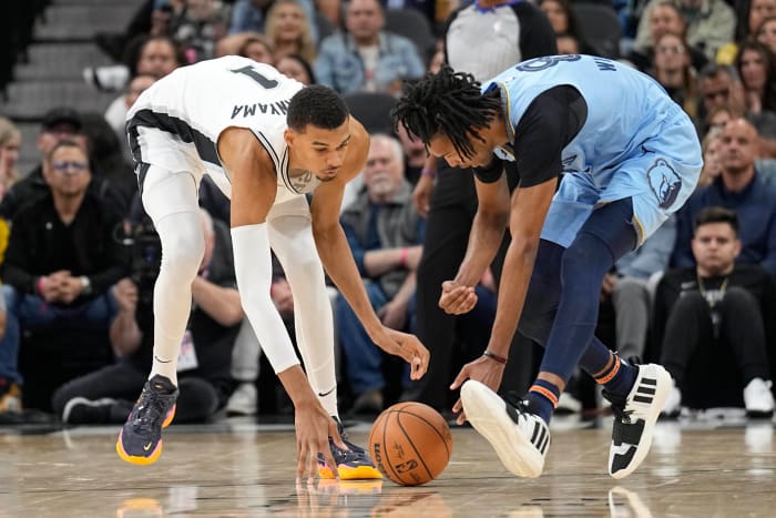 Nov 18, 2023; San Antonio, Texas, USA; Memphis Grizzlies forward Ziaire Williams (8) and San Antonio Spurs forward Victor Wembanyama (1) battle for a loose ball during the second half at Frost Bank Center.